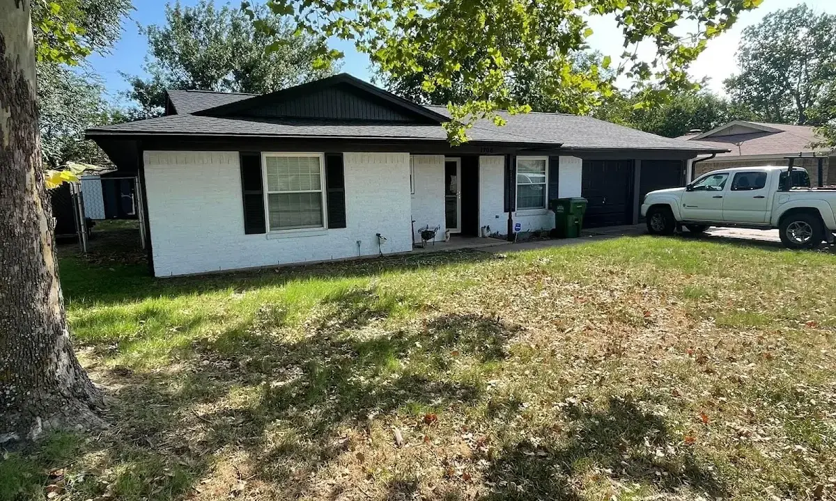 Professional roofing crew working on a residential roof in Tehaleh